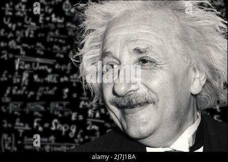 Albert Einstein, against a background full of mathematical formulas Stock Photo