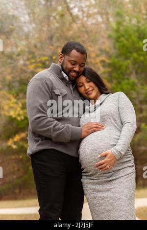 Portrait of a mixed race couple who are expecting parents Stock Photo