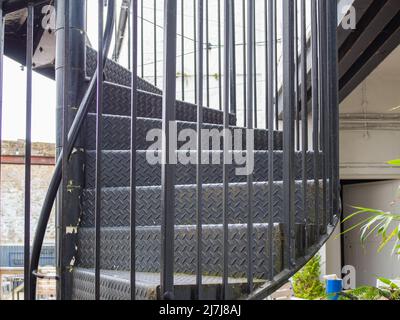 06.05.2022 Settle, North Yorkshire, Uk  A metal spiral staircase in dark grey in the Lion pub in Settle Stock Photo