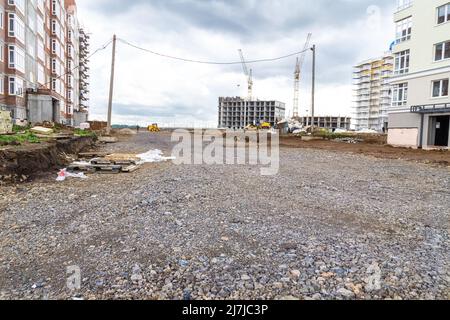 filling with rubble the roadway of the courtyard area of houses under construction, selective focus Stock Photo
