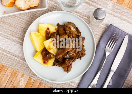 Fried rabbit liver served with boiled potato Stock Photo
