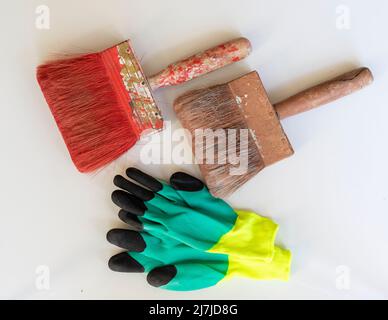 Two old worn and gloves on the white isolated background Stock Photo