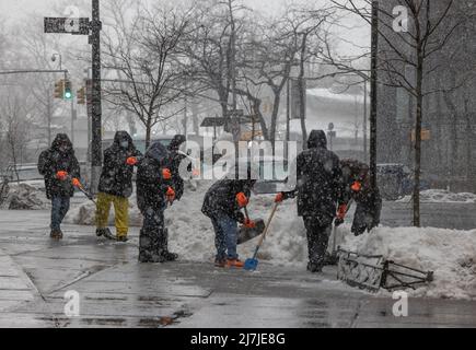NEW YORK, N.Y. – February 7, 2021: A crew works during a winter storm to remove snow from a prior downfall in Lower Manhattan. Stock Photo