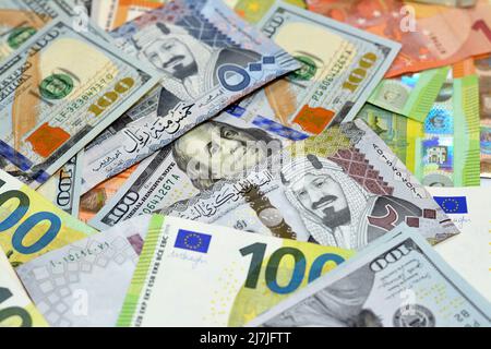 Saudi riyals money with American dollars bills and European euros banknotes, a pile of 200 and 500 Saudi Arabia riyals, 100 one hundred dollars and 10 Stock Photo