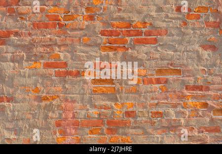 Weathered brick and stucco building facade Stock Photo