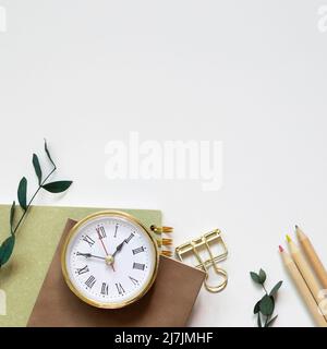 Notebook, pencil, clip, clock on white background. flat lay, top view, copy space Stock Photo