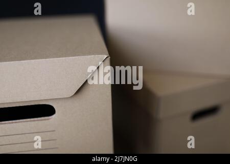 Empty solid cardboard boxes with covers, beige containers to storage things Stock Photo