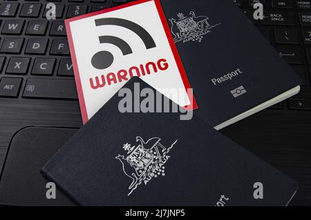 passports and WIFI security warning sign on a computer keyboard Stock Photo