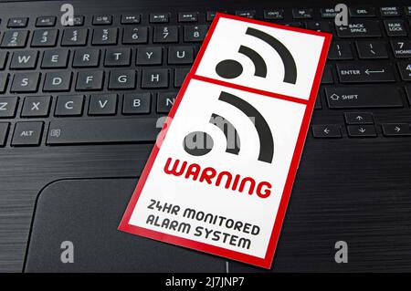 computer WIFI warning sign on a black laptop keyboard Stock Photo