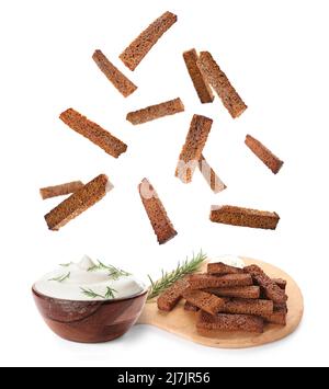 Falling rye croutons with sour cream and dill on white background Stock Photo