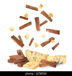 Falling rye croutons with cheese on white background Stock Photo