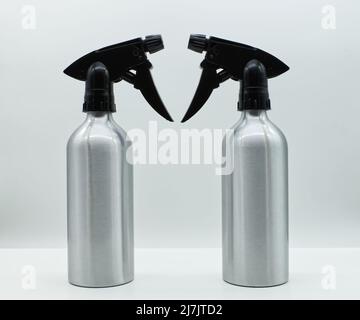 Silver spray bottle isolated on white background. Spry bottle without label for house cleaning. Cleaning service concept. Stock Photo