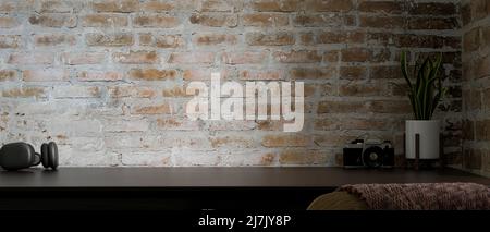 Stylish vintage workspace interior design with accessories and copy space on dark wood tabletop over vintage grunge brick wall. 3d rendering, 3d illus Stock Photo
