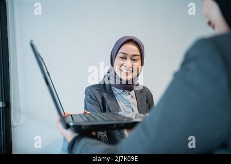 muslim female worker presentation with her partner at the office Stock Photo