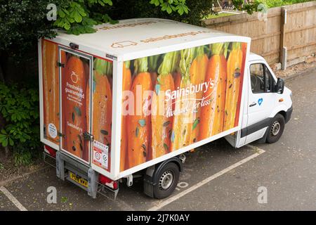 A Sainsbury online shopping delivery van parked for food delivery with the Sainsburys logo in Basingstoke. England Stock Photo