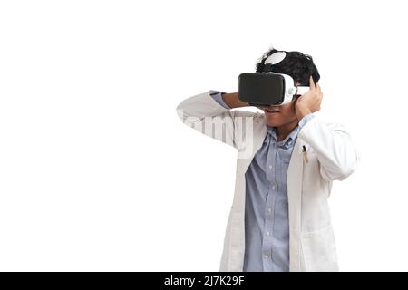 Young peruvian male scientific using virtual reality headset, isolated. Stock Photo