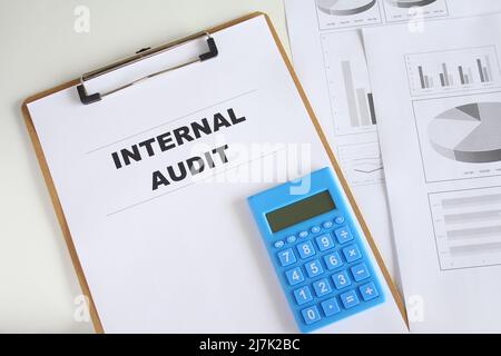 Audit word on working paper with pen, measuring tape and calculator. Business improvement and quality management system concept. Stock Photo