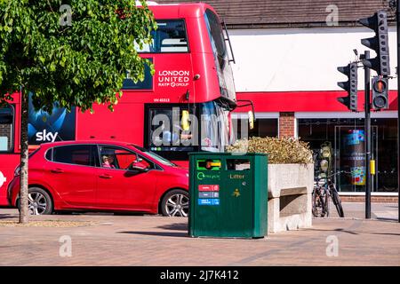 Epsom Surrey, London, May 09 2022, Red London double Decker Bus And Red Passenger Car Waiting At Traffic Lights Stock Photo