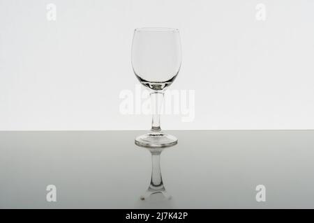 Empty wine glass with reflection on background, front view Stock Photo