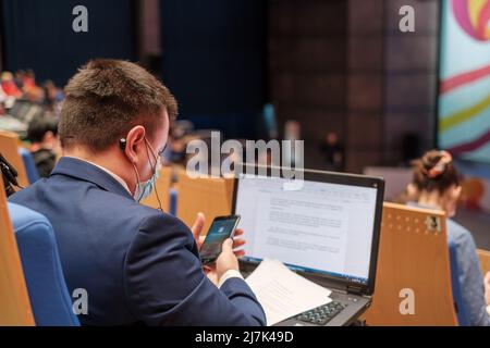 Businessman using laptop during seminar Stock Photo