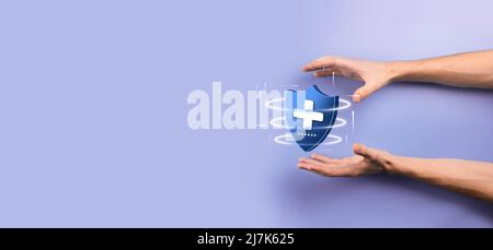 Businessman hold Shield with plus Low polygonal icon, medicine icon.Health shield.Medical logo template,protection symbol with cross sign,healthcare s Stock Photo