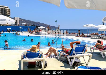 FUNCHAL, PORTUGAL - AUGUST 29, 2021: Unidentified people are relaxing at the Do Lido beach complex. Stock Photo