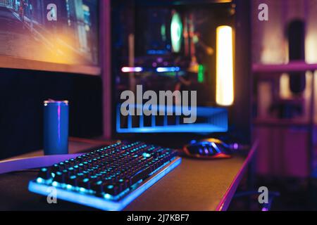 Close-up of empty gaming streaming studio equipped during first person shooter online competition. Professional setup with powerful computer, keyboard, monitor and mouse ready for online championship  Stock Photo