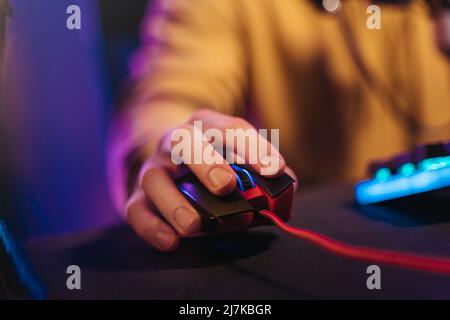 Closeup of esport gamer's hand on professional computer mouse, close up, selective focus on hand. Professional equipment for computer games. Cyber sport concept. Blur background Stock Photo