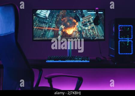 Empty home gaming studio of cyber sportsman in neon lights. Professional gaming setup for playing online video games and live streaming. Shooters, cyber sport, esport concept Stock Photo