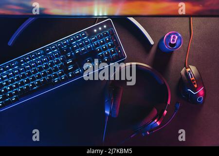 Close-up of black desktop with professional gaming and streaming setup, keyboard, monitor, computer mouse, headset. Gamer's equipment ready for online championship and streaming. Cyber sport concept Stock Photo