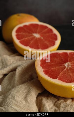 sliced ripe grapefruit on a light cloth Stock Photo