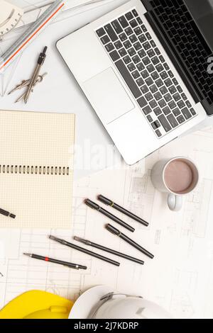 Mockup of architectural concept, Drawing tool and coffee on drawing of blueprint with safety helmet. Stock Photo