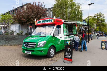 Mr Whippy ice cream vendor selling to customers from his green van in Bowness on Windermere in the Lake District,England,UK Stock Photo