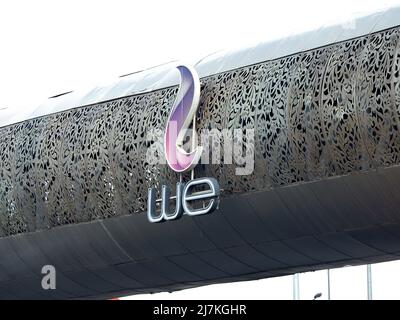 Giza, Egypt, December 30 2021: sign and symbol of Telecom Egypt company WE that provides telecommunication services in Egypt including landlines, cell Stock Photo
