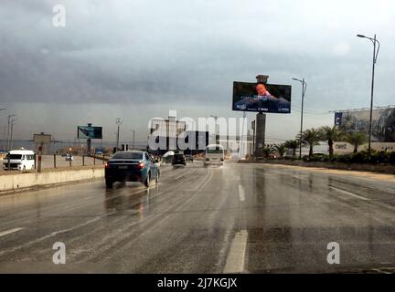 Giza, Egypt, December 30 2021: raining weather, traffic on a cloudy day bad weather condition during rains, road view through car window blurry with h Stock Photo