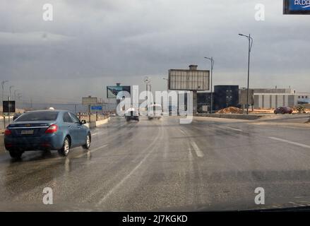 Giza, Egypt, December 30 2021: raining weather, traffic on a cloudy day bad weather condition during rains, road view through car window blurry with h Stock Photo
