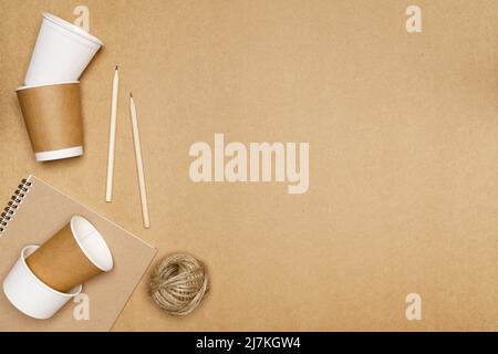 Eco friendly concept, Notebook with pencil and paper cup with jute rope on wooden background. Stock Photo