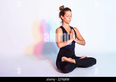 Smiling Asian female in cap taking picture of green olive tree on modern smartphone while standing in grove Stock Photo