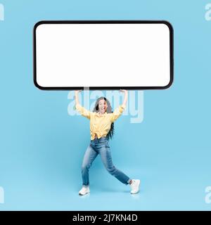 Excited lady holding heavy white empty smartphone screen Stock Photo