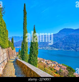 The hill of Morcote opens the view on the Lake Lugano, Alpine scenery, old town roofs and tall cypress trees, Switzerland Stock Photo