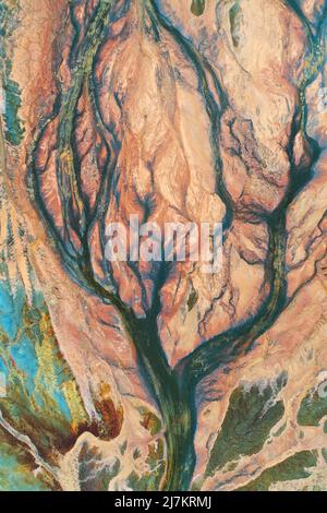 Full frame of abstract background with cracks in shape of tree with branches on rough stone surface with colorful spots Stock Photo