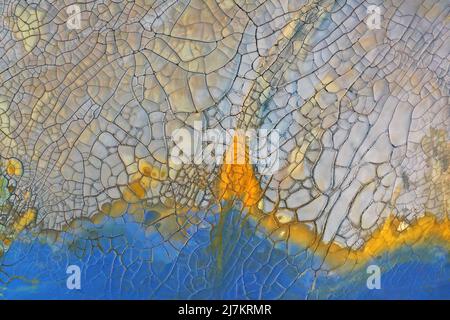 Aerial view full frame of abstract background with cracks on gray and blue surface with dried texture and blue stains Stock Photo