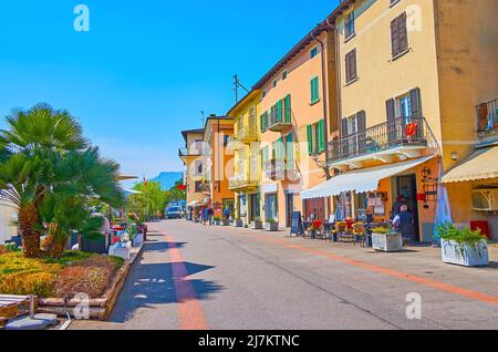 MORCOTE, SWITZERLAND - MARCH 25, 2022: Riva dal Garavell embankment of Lake Lugano is the nice place to relax in cafe and enjoy the views, on March 25 Stock Photo