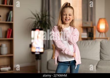 Little Girl Making Video For Blog Via Phone At Home Stock Photo