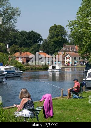 The River Bure on The Norfolk Broads at Coltishall, popular for picnicking & fishing, as well as boating, Coltishall, Norfolk, England, UK, Stock Photo