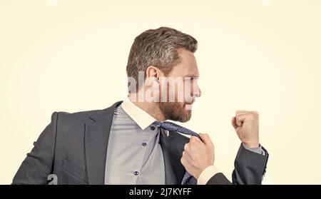 Aggressive professional business man shake fist to male adult pulling his necktie, aggression Stock Photo