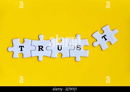 Word trust on missing jigsaw puzzle. Conceptual Stock Photo