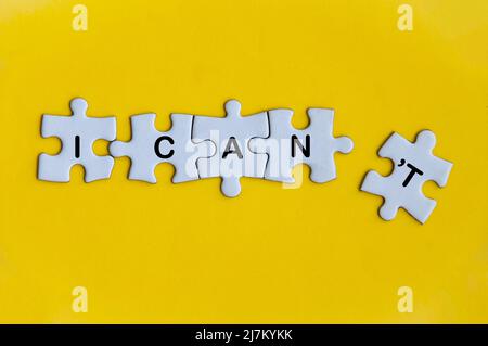 I can't text on missing jigsaw puzzle on yellow cover background. Motivational concept. Stock Photo