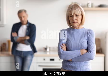 Upset mature lady crying, having quarrel with her husband Stock Photo