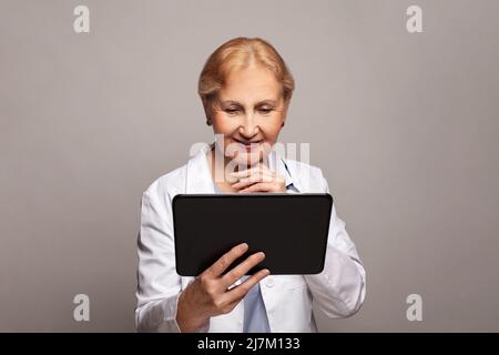 Smiling medical doctor woman using tablet pc Stock Photo